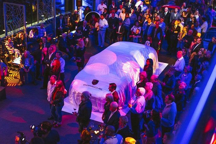 Guests gathered around illuminated tables at the Porsche Exchange grand opening